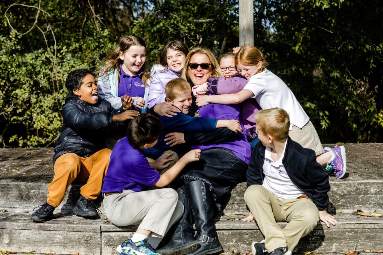 Citadel Christian School students hugging teacher
